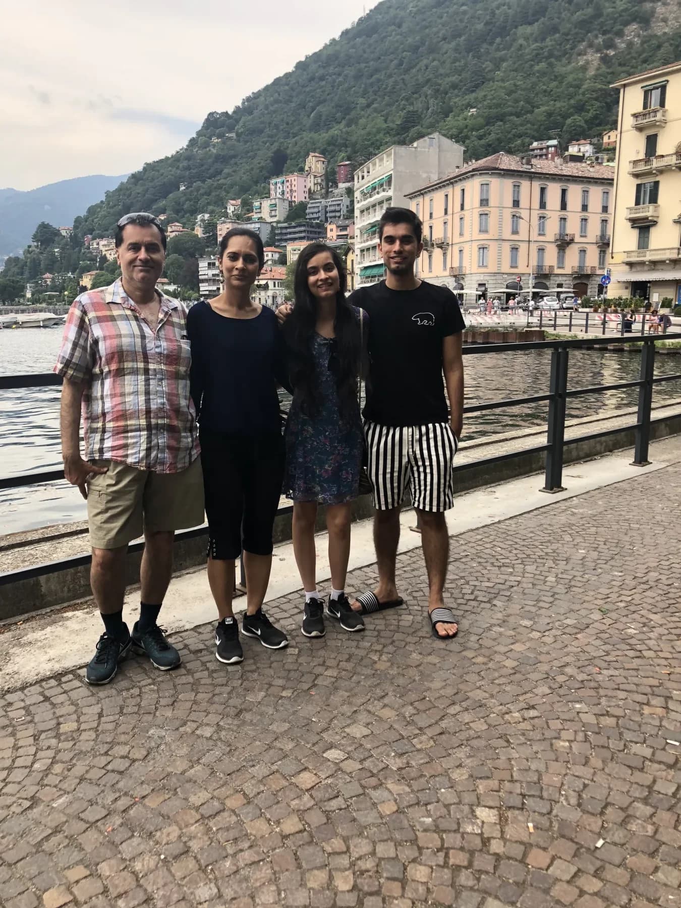 Jasmeen and her family together beside a lakeside town