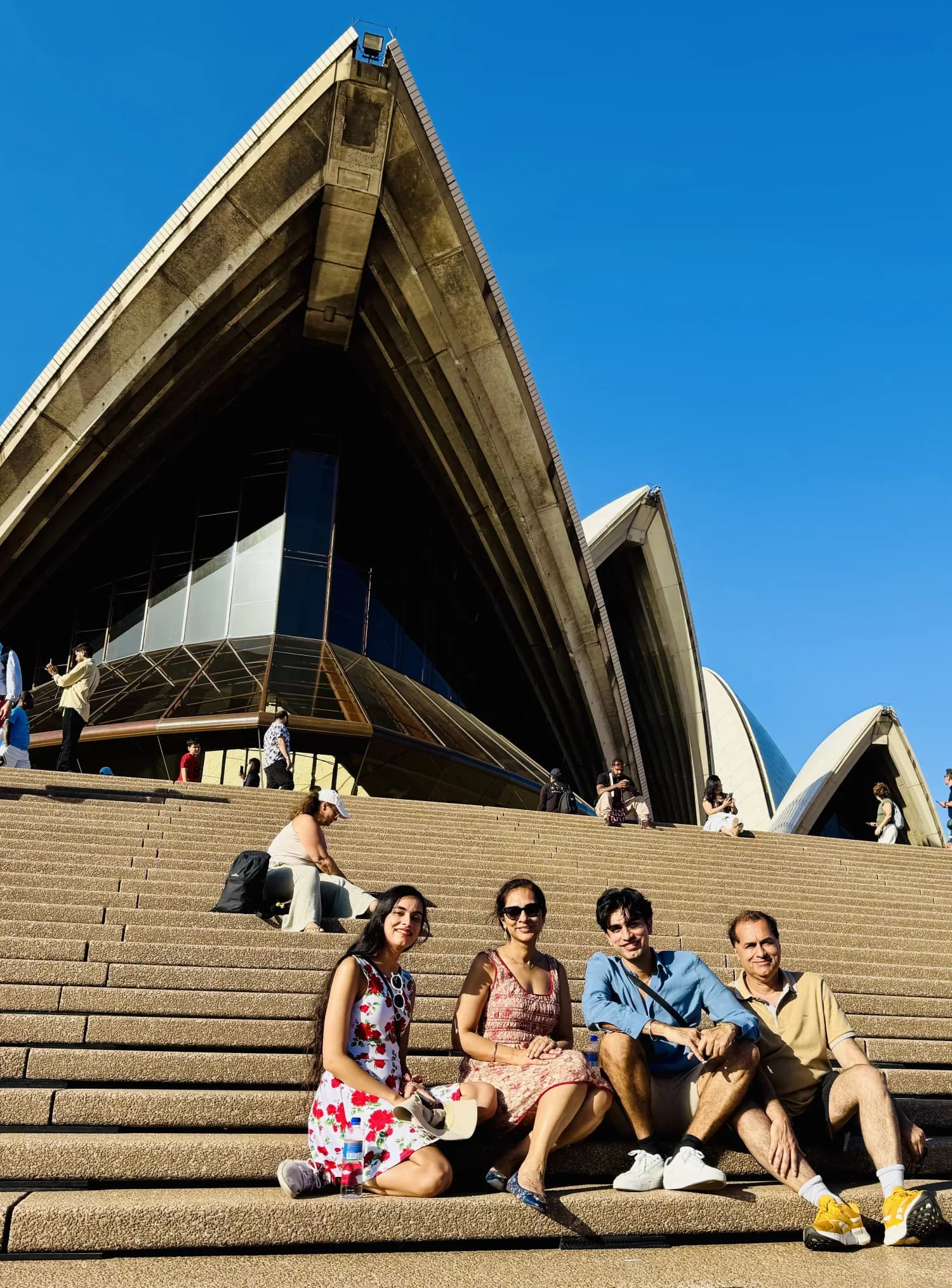Jasmeen and her family together on the steps of the Sydney Opera House